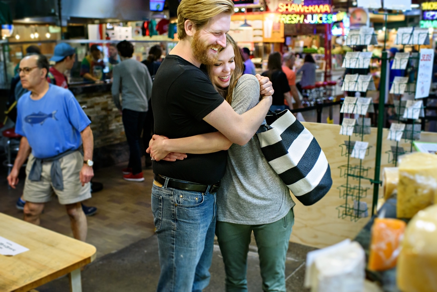 A couple shop in Reading Terminal Market for their engagement session in Philadelphia.